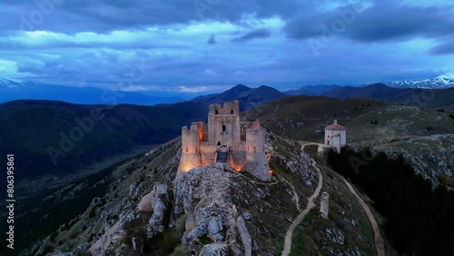 An illuminated Rocca Calascio castle in Abruzzo, Italy with the Church of the Madonna della Pieta photo
