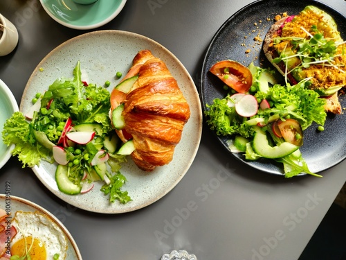 Croissant and Microgreens and Avocado Toast Breakfast Served on Plates