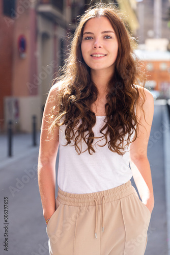 Young cheerful woman walking in historic city center