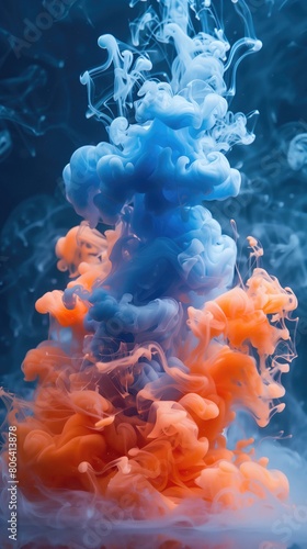Colorful ink in water on a blue background. Abstract vertical background.