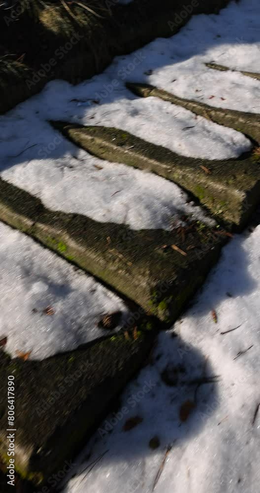 a snow-covered abandoned concrete staircase in the park, an old staircase of several steps on a hill a snow-covered abandoned concrete staircase in the park, an old staircase of several steps on a hill