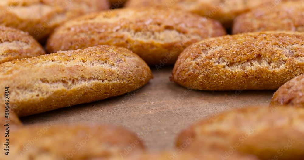 high-calorie custard cookies on paper, delicious sweet cookies with sugar on the table high-calorie custard cookies on paper, delicious sweet cookies with sugar on the table