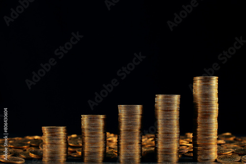 A large variety of coins on a black background. Stack of coins