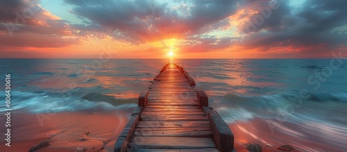 Old wooden pier on the beach at sunrise, wide copy space