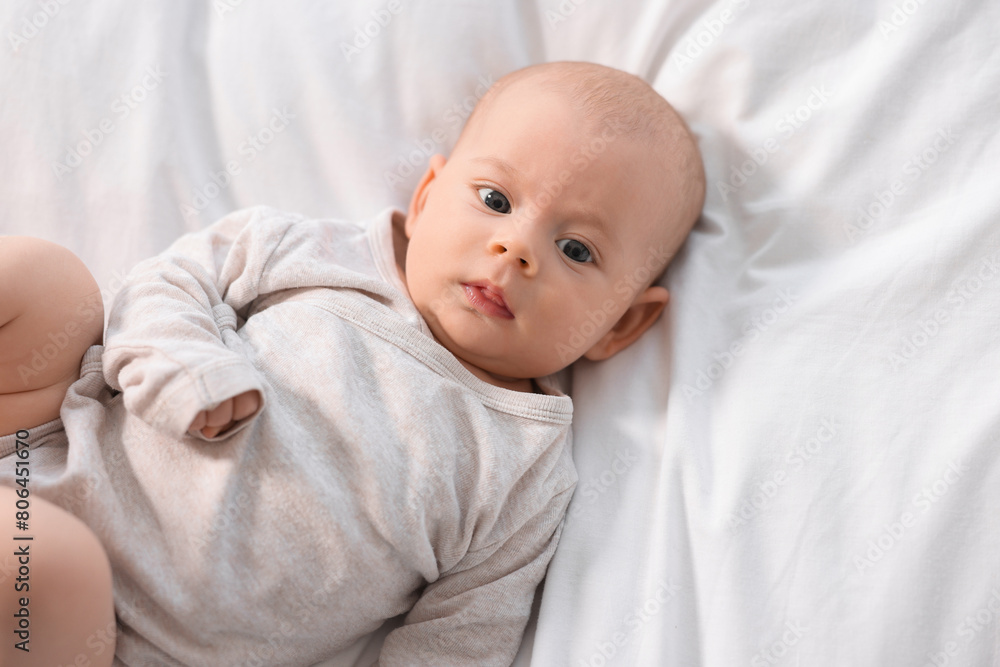 Cute little baby lying on white sheets, top view Cute little baby lying on white sheets, top view