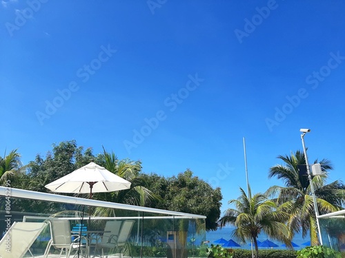 Beautiful swimming pool in hotel resort with blue sky and white cloud