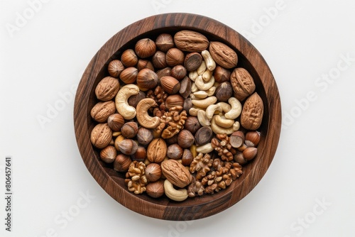 Top view of various nuts in a wooden bowl on a white background. AIG51A. © Summit Art Creations