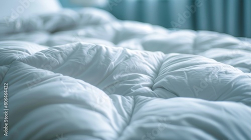 A closeup of a downfilled comforter plump and inviting promising a comfortable and lavish nights sleep. photo