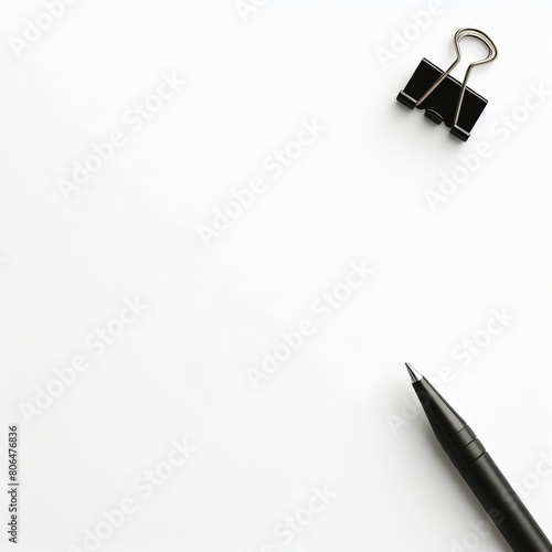 Plain white background with a paper clip and pen for editorial use