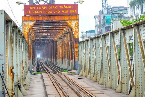 Vintage railroad tracks leading over the famous Long Bien Bridge, Hanoi, Vietnam. This is the railway line was built so long and still in operation today