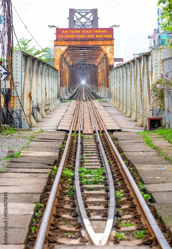 Vintage railroad tracks leading over the famous Long Bien Bridge, Hanoi, Vietnam. This is the railway line was built so long and still in operation today