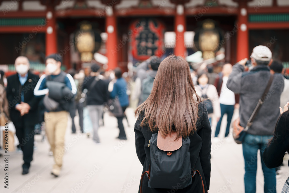 Tourist woman visit Sensoji Temple or Asakusa Kannon Temple is a Buddhist temple located in Asakusa, Tokyo Japan. Japanese sentence on red lantern means Thunder gate. Tourist woman visit Sensoji Temple or Asakusa Kannon Temple is a Buddhist temple located in Asakusa, Tokyo Japan. Japanese sentence on red lantern means Thunder gate.