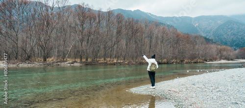 Woman tourist travel Kamikochi National Park  happy Traveler sightseeing Tashiro pond with mountain  Nagano Prefecture  Japan. Landmark for tourists attraction. Japan Travel  Destination and Vacation