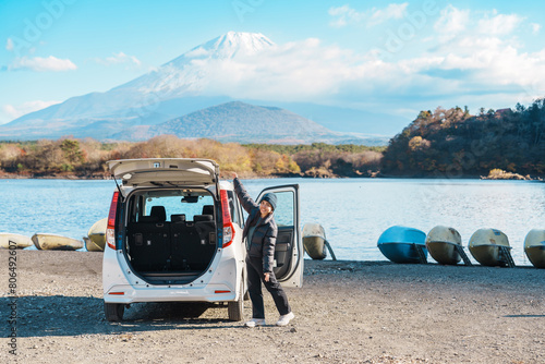 Photography Woman tourist enjoy with Fuji Mountain at Lake Shoji, happy Traveler sightseeing Mount Fuji and road trip Fuji Five Lakes