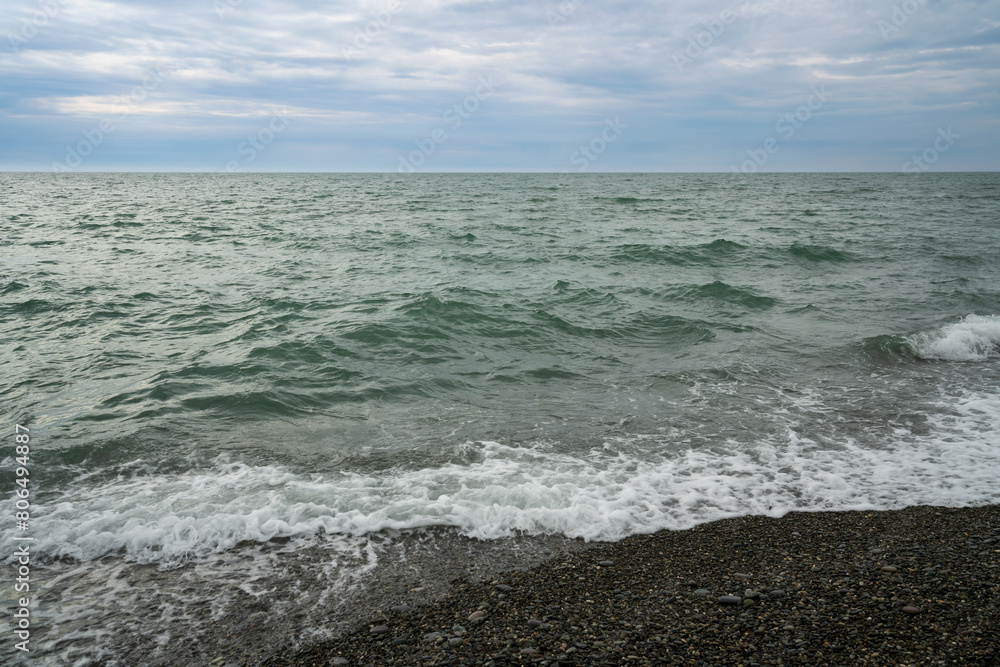 Black Sea on the Sochi coast and a pebble beach on a sunny day with clouds, Sochi, Krasnodar Territory, Russia Black Sea on the Sochi coast and a pebble beach on a sunny day with clouds, Sochi, Krasnodar Territory, Russia