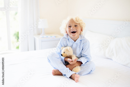 Kids in bed. Children in pajamas. Family bedroom.