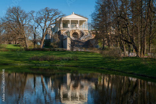 View of the Cameron Gallery on the shore of a large pond in Catherine Park of Tsarskoye Selo on a sunny spring day, Pushkin, St. Petersburg, Russia © Ula Ulachka