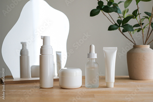 Cosmetic set with mirror on wooden table.