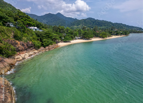 Aerial view of the west coast of Koh Chang island in eastern Thailand with long white sand beach and clear green water