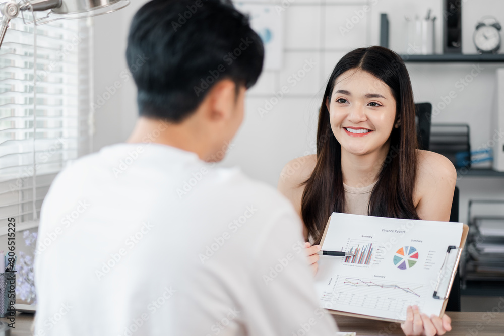 Smiling woman confidently presents a financial report during a productive meeting with her colleague. Smiling woman confidently presents a financial report during a productive meeting with her colleague.