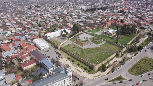 Scenic view from drone of central areas of Telavi city overlooking medieval walled Batonis Tsikhe fortress on spring day, Georgia photo