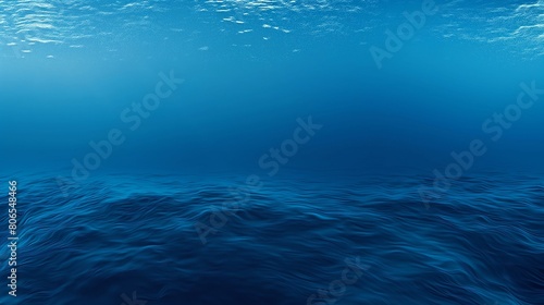 A panoramic view of a deep, royal blue solid color texture, resembling the calm depths of the ocean, with faint, ripple-like indentations suggesting the gentle movement of water.  photo