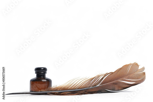 An antique quill next to an inkwell