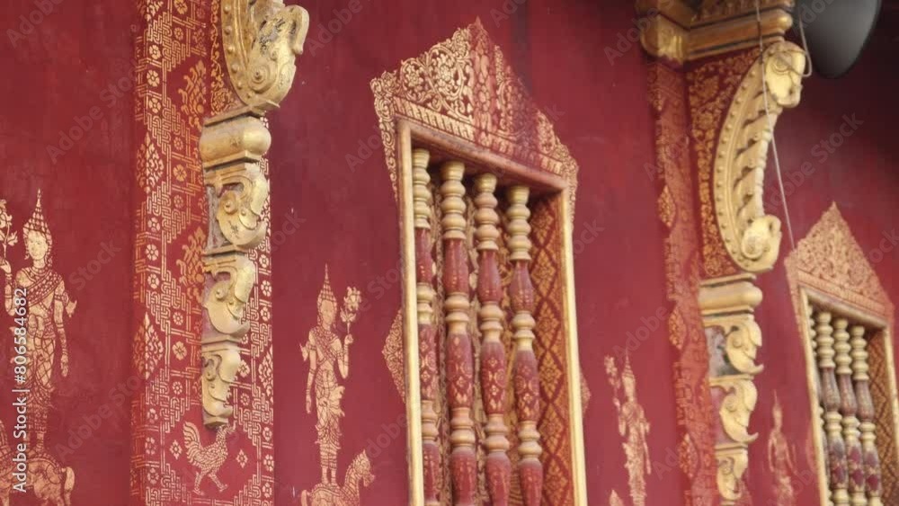 red and gold designs on wall of buddhist temple in Luang Prabang, Laos traveling Southeast Asia red and gold designs on wall of buddhist temple in Luang Prabang, Laos traveling Southeast Asia