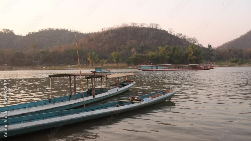 boats docked on the mekong river in Luang Prabang, Laos traveling Southeast Asia boats docked on the mekong river in Luang Prabang, Laos traveling Southeast Asia