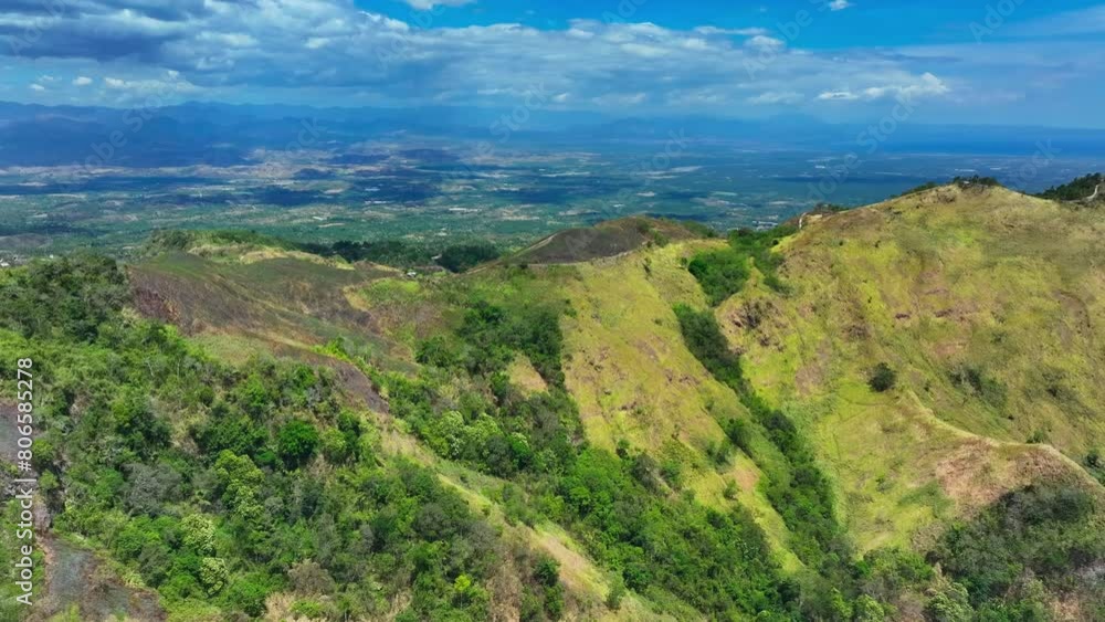 Green Mountains with path on peak on Mindanao Island, Philippines in summer. Sarangani bay in the background. Green Mountains with path on peak on Mindanao Island, Philippines in summer. Sarangani bay in the background.