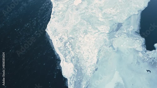aerial view of froze ice glacier melting in artic drone fly close to glacier melting causing rising sea level global warming climate change concept