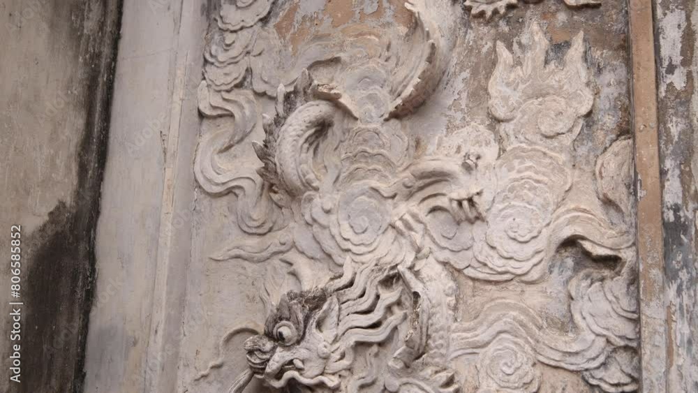 dragon relief carved into a wall in Hanoi the capital city of Vietnam in Southeast Asia dragon relief carved into a wall in Hanoi the capital city of Vietnam in Southeast Asia
