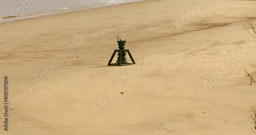 long shot of the tide and time bell at Happisburgh beach in March 2024. photo