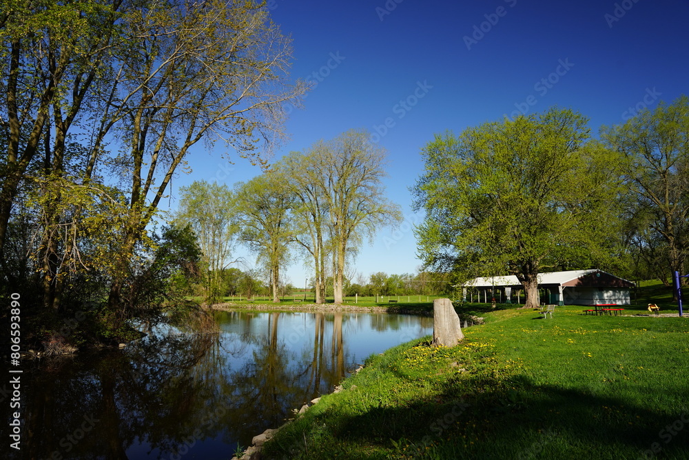 Grassy field park near a river reflecting the landscape. Grassy field park near a river reflecting the landscape.