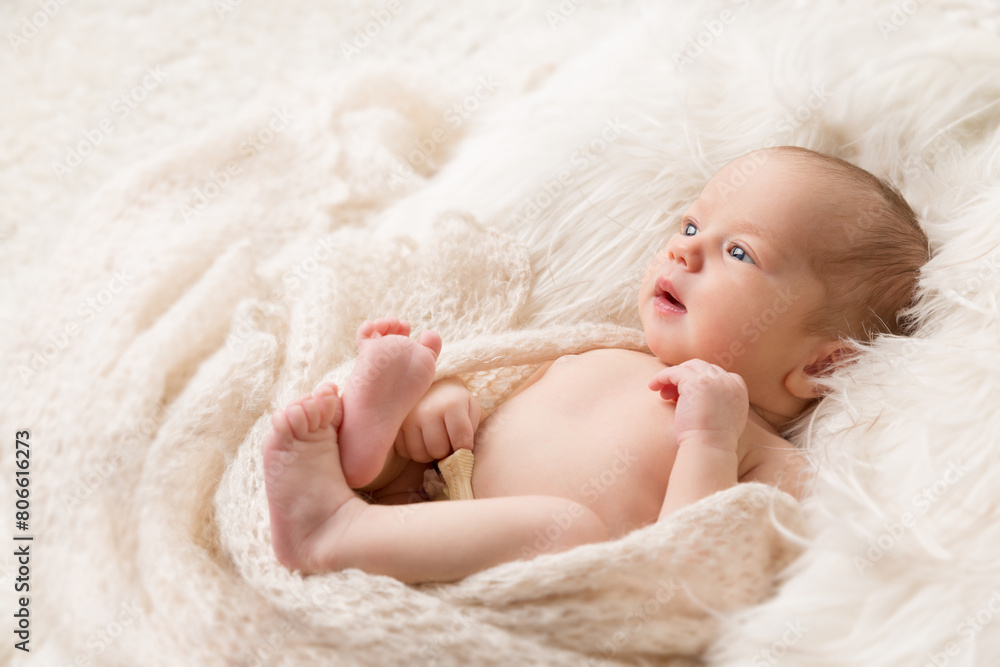 Baby looking up lying on Beige Blanket in Crib. Newborn Navel Treatment. One month Child Health Skin Care. Infant Development. Neonatal Medicine Baby looking up lying on Beige Blanket in Crib. Newborn Navel Treatment. One month Child Health Skin Care. Infant Development. Neonatal Medicine