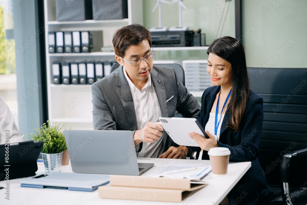 Happy businesspeople while collaborating on a new project in an office. Group of diverse businesspeople Happy businesspeople while collaborating on a new project in an office. Group of diverse businesspeople