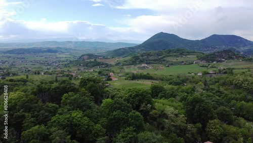 Aerial view above the scenic italian landscape of the Colli Euganean hills with agricultural vineyard fields and villages in the distance. photo