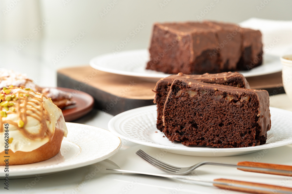 Homemade desserts sponge cake and cinnamon bun on table