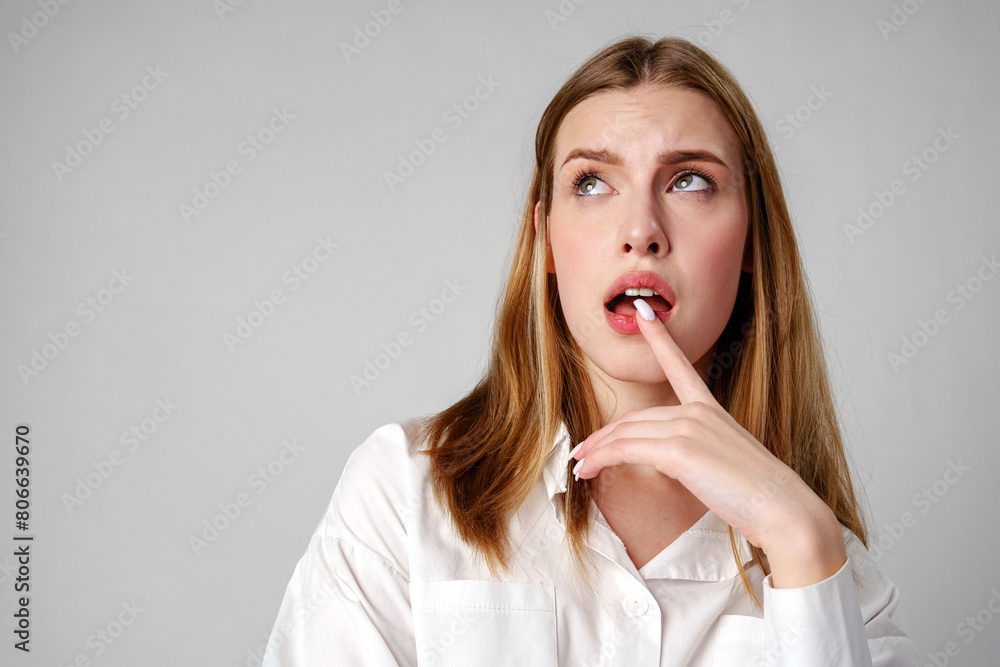 Woman in White Shirt Holding Finger to Lips Woman in White Shirt Holding Finger to Lips