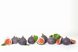 Fresh ripe figs with leaves on a white background