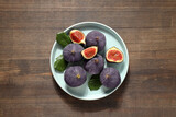 Fresh ripe figs in a bowl on a wooden background