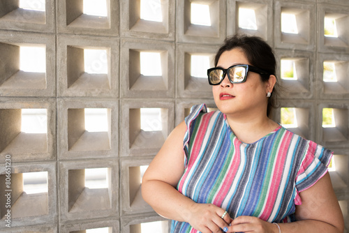 Portrait of Beautiful Smiling Plus Size Woman Wearing Sunglasses and Casual Dress