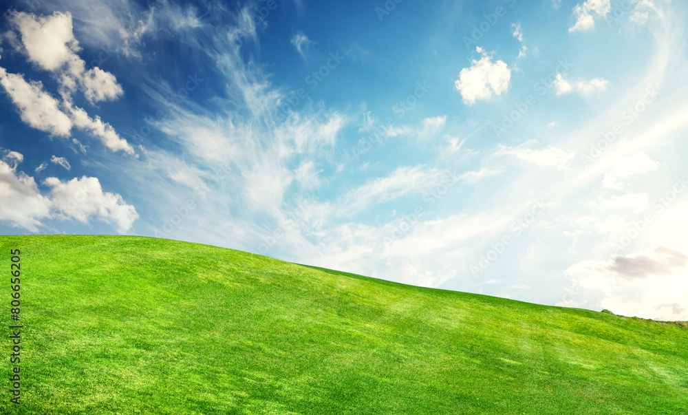 A sunny landscape unfolds, featuring meticulously trimmed green grass under a majestic sky A sunny landscape unfolds, featuring meticulously trimmed green grass under a majestic sky