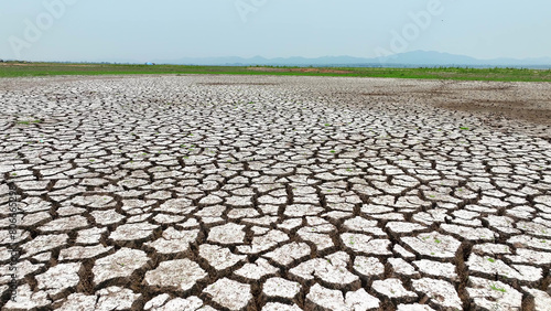 From above, cracked soil unveils intricate patterns, a solemn portrayal of arid landscapes. Drone imagery exposes nature's scars, a poignant reminder of environmental degradation.
