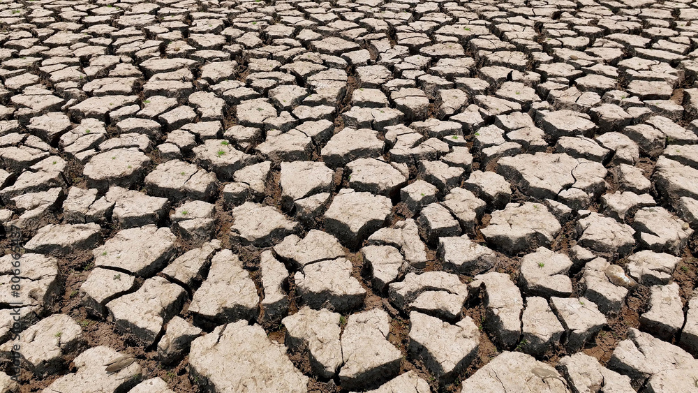 A bird's-eye view reveals the desolate landscape, cracked and barren, a testament to relentless drought. This stark image epitomizes environmental crisis and the urgent need for water conservation.
A bird's-eye view reveals the desolate landscape, cracked and barren, a testament to relentless drought. This stark image epitomizes environmental crisis and the urgent need for water conservation.