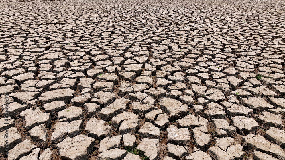 Behold the desolation from above, an arid expanse with earth cracked open, sparse greenery clinging to survival. This drone's eye view captures the raw reality of drought's relentless grasp.
Behold the desolation from above, an arid expanse with earth cracked open, sparse greenery clinging to survival. This drone's eye view captures the raw reality of drought's relentless grasp.