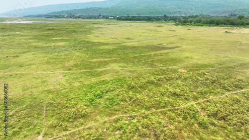 From above, dwindling water levels and muddy shores starkly reveal drought's impact, emphasizing environmental and water scarcity challenges. 