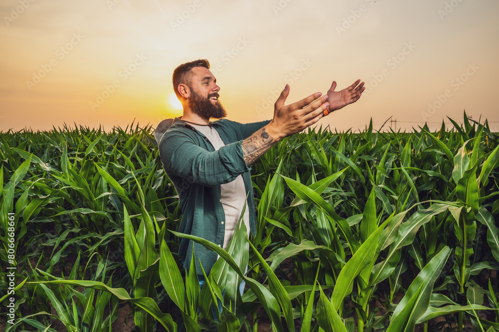 Portrait of farmer who is cultivating corn. He is satisfied with good progress of plants. Agricultural occupation. Portrait of farmer who is cultivating corn. He is satisfied with good progress of plants. Agricultural occupation.