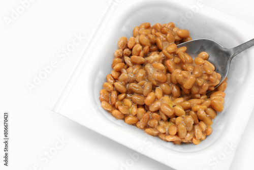 Close up of Natto or Fermented Soybean with stainless spoon isolated on white background. Traditional food in Japan. Ready to eat