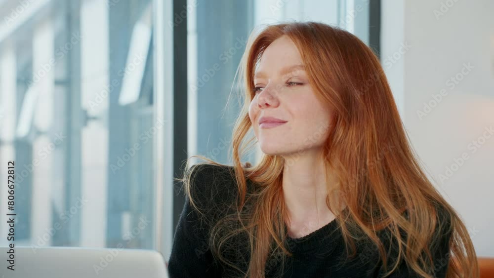 Successful redhead woman in modern office using laptop Successful redhead woman in modern office using laptop